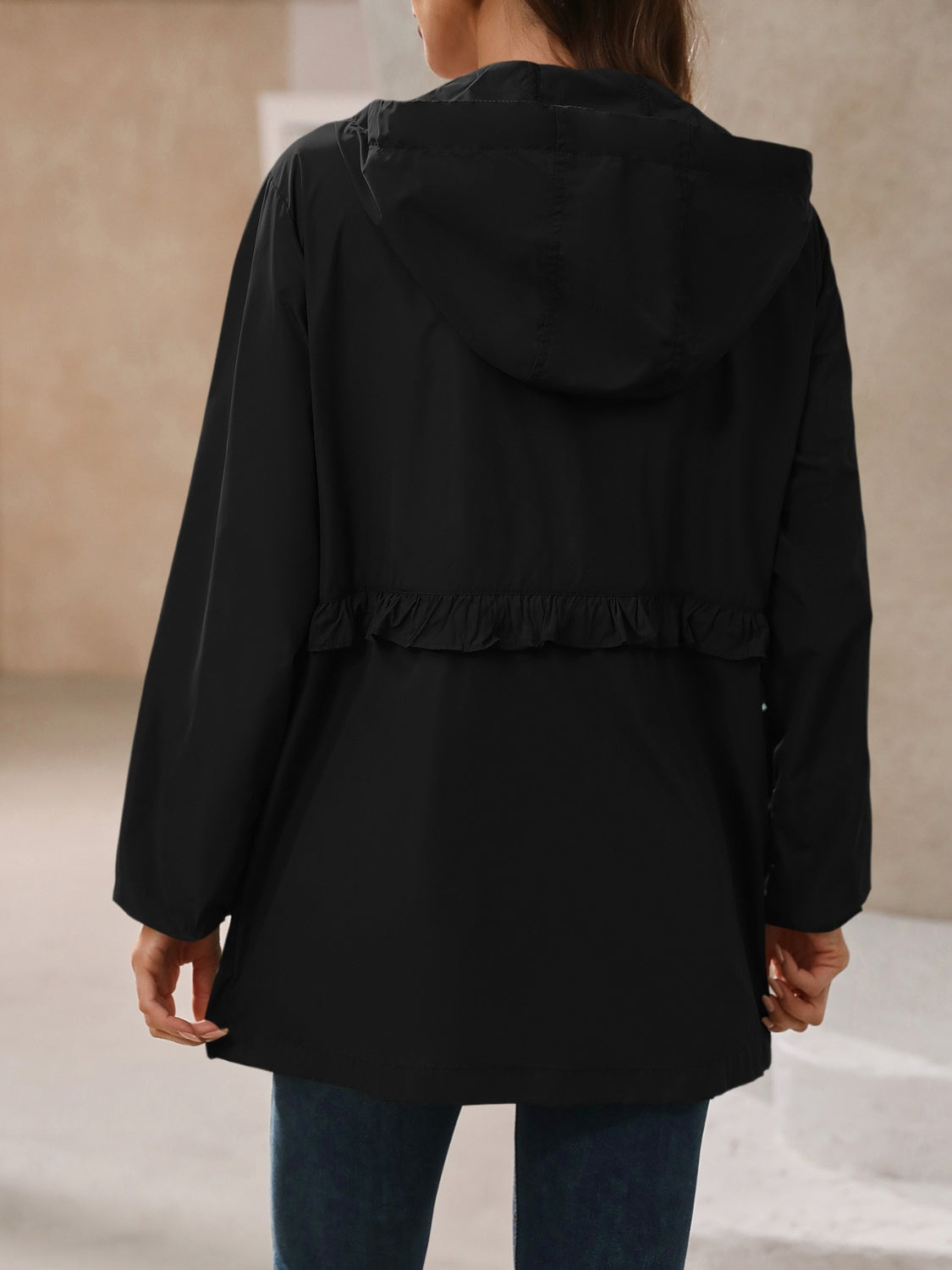 Black hooded windbreaker jacket with ruffled waistline detail
