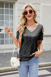 Black sequin cold shoulder blouse with criss-cross neckline detail.
