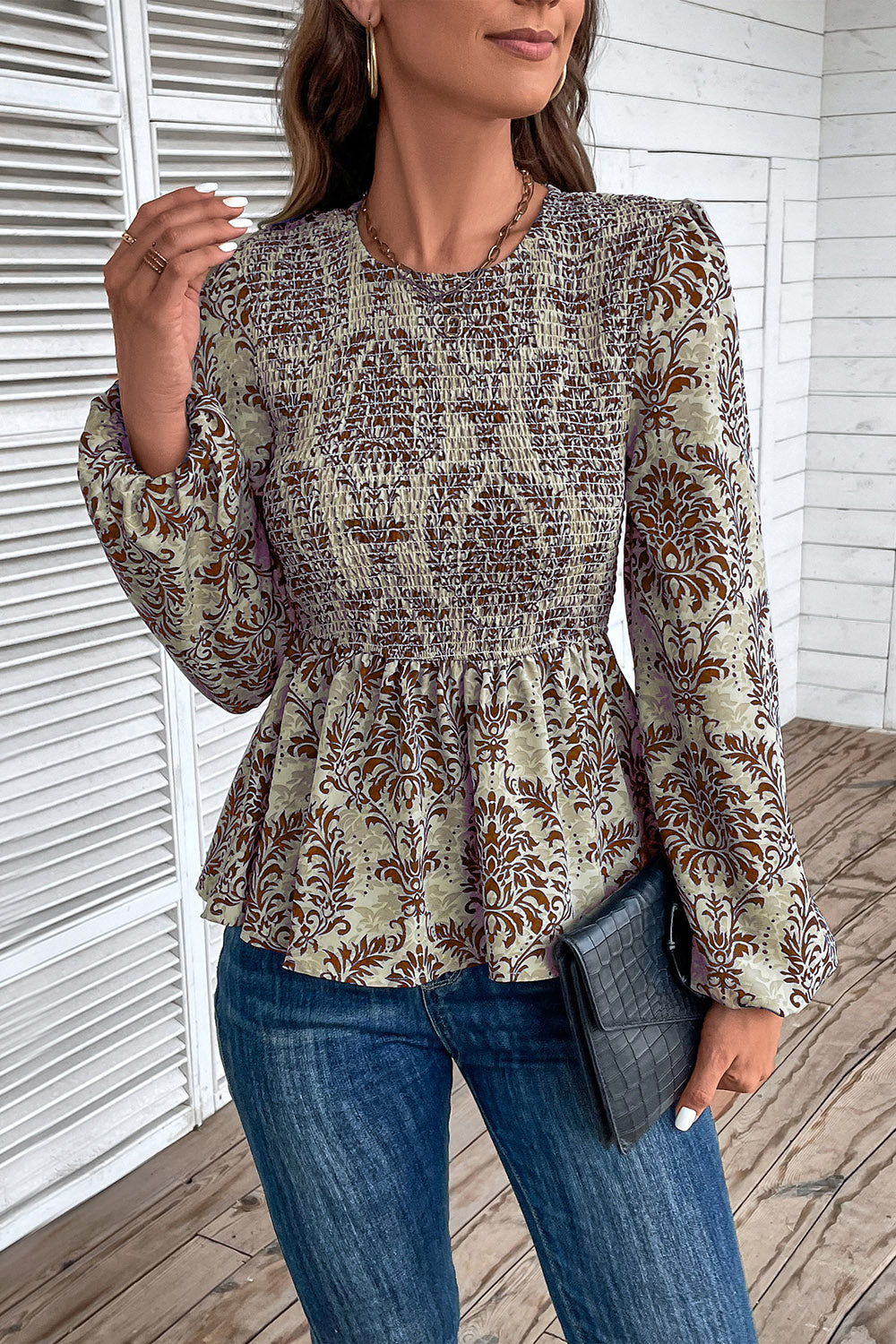 Brown damask print peplum blouse with smocking and bishop sleeves.