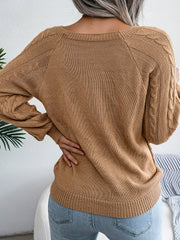 Khaki cable-knit sweater with buttoned shoulder detail and raglan sleeves.