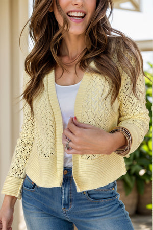 Pastel yellow open-knit pointelle edge cardigan with ribbed cuffs and hem.
