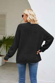 Black waffle knit raglan pocket cardigan with long sleeves and crew neck.