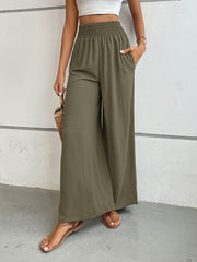 Moss green textured palazzo lounge trousers with smocked waist and pockets.