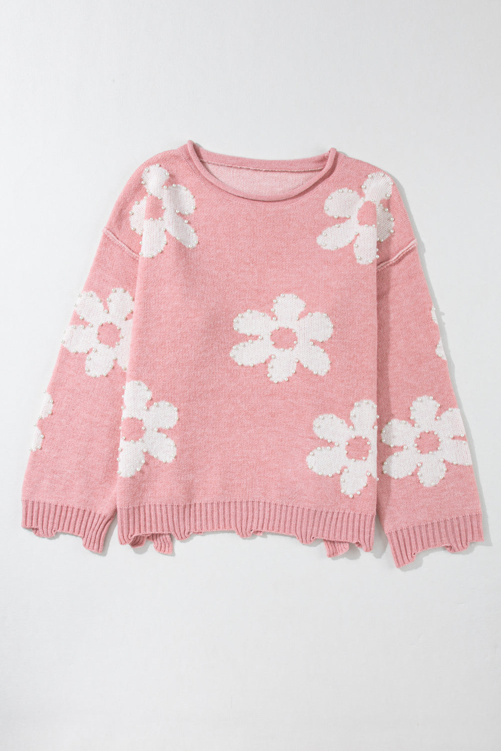 Blush pink knit sweater with white floral appliques and pearl details.