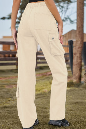 Tan denim cargo pants with relaxed wide legs and utility pockets.