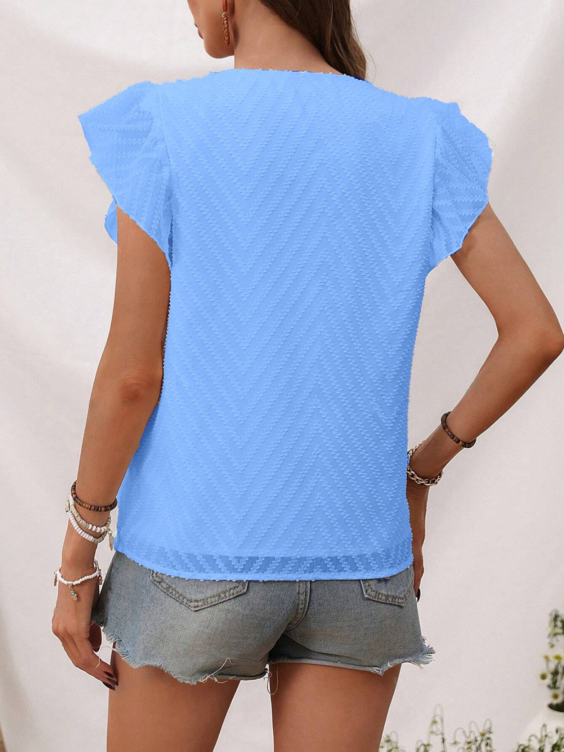 Sky blue textured chevron flutter sleeve blouse with sheer hem