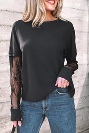 Black relaxed fit t-shirt with sheer lace sleeves featuring a bow pattern.
