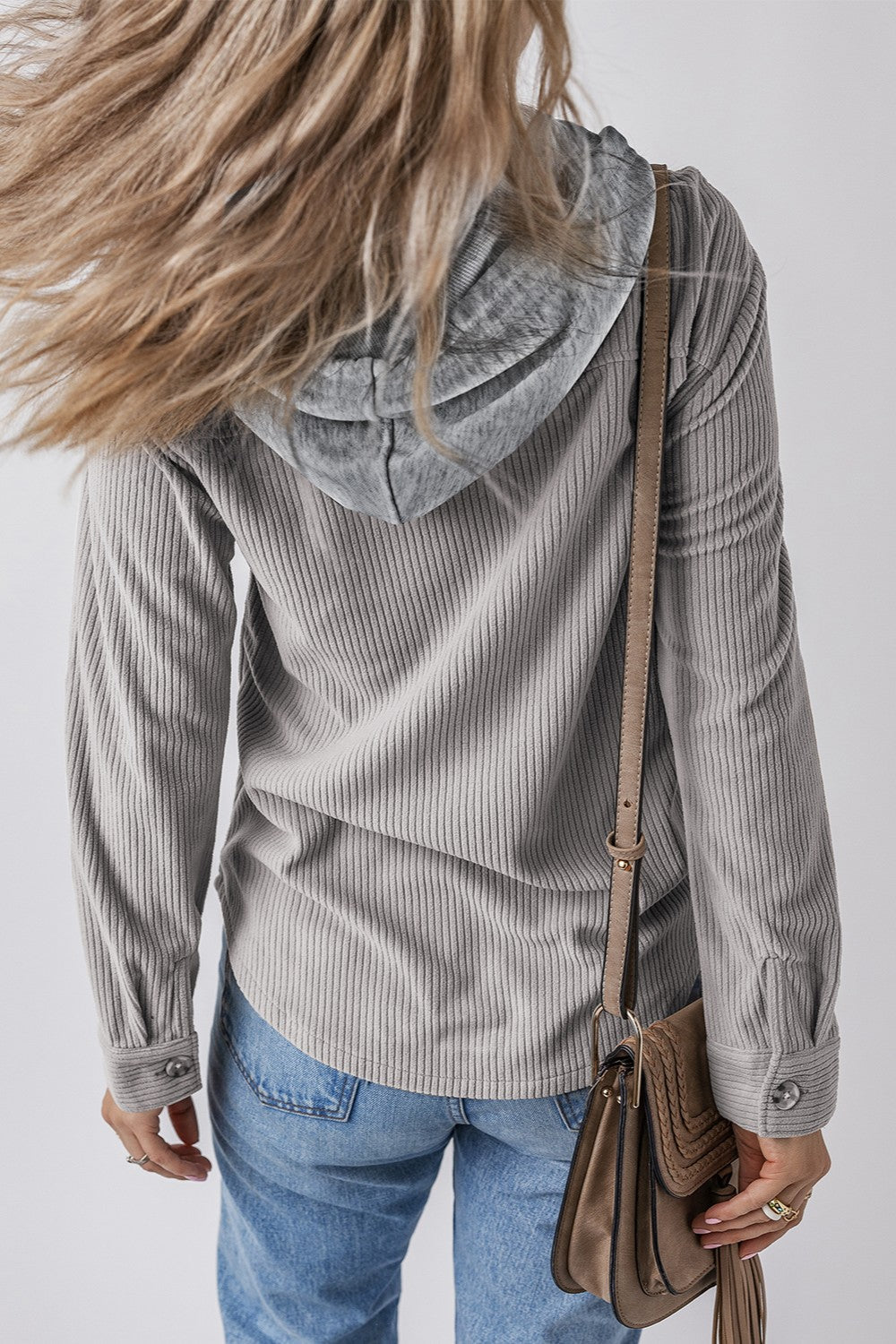 Gray corduroy shirt jacket with contrast hood and button cuffs, worn with jeans.