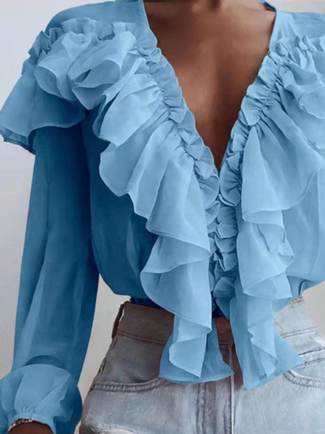 Sky blue chiffon blouse with cascading ruffles and plunging neckline