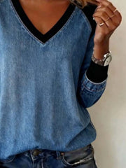 Patchwork V-neck denim blouse with black accents and banded cuffs.
