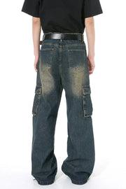 Dark wash distressed wide-leg cargo jeans with zippered pockets.