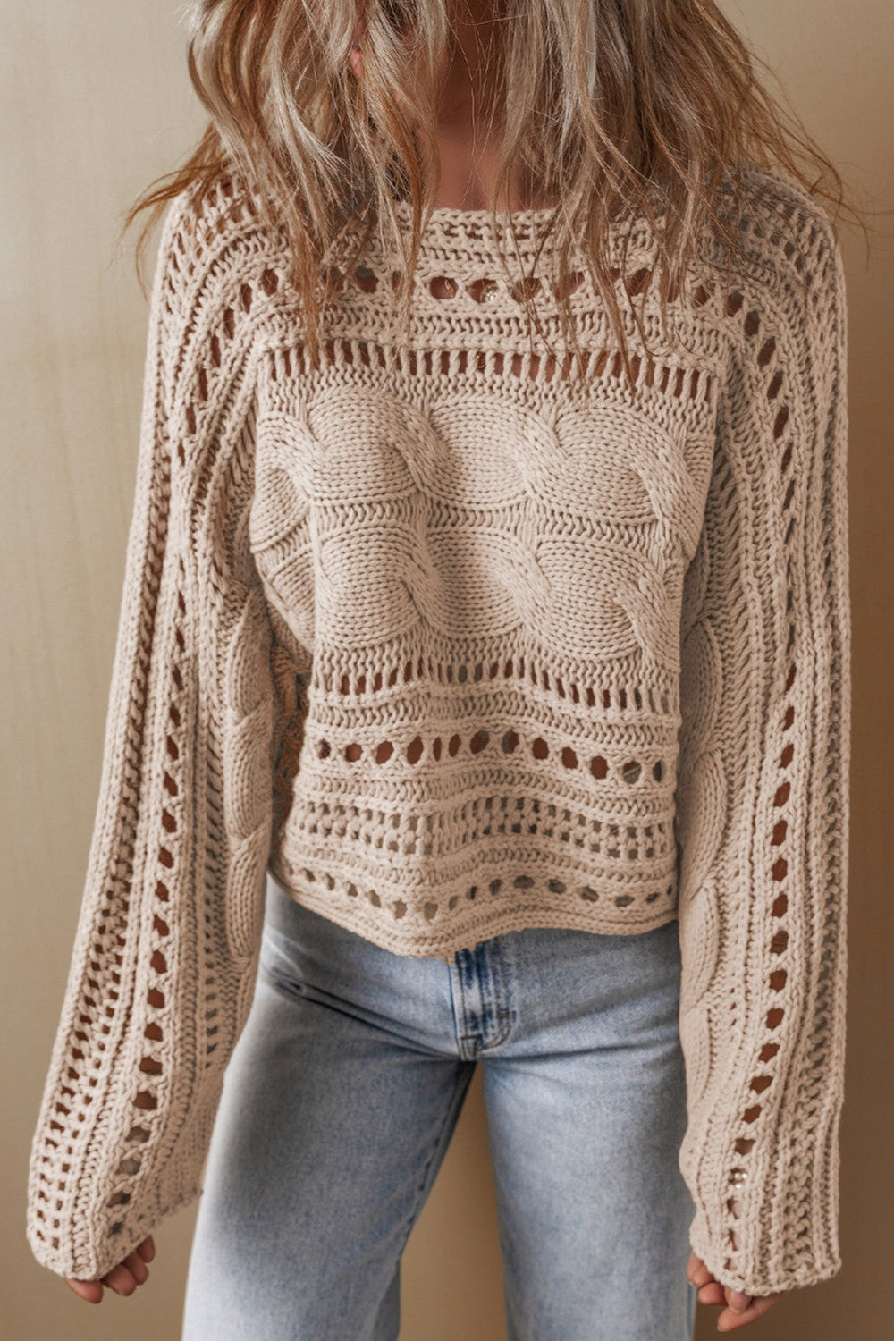 Dust Storm acrylic cable knit sweater with cutout details and crew neck.