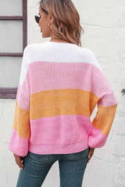 Ribbed knit sweater with balloon sleeves in pink, orange, and white stripes.
