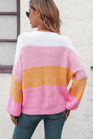 Ribbed knit sweater with balloon sleeves in pink, orange, and white stripes.