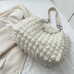 Textured grid pearl chain tote bag in ivory with a bubble-like fabric and chain detail.