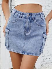 Medium wash denim cargo mini skirt with front pockets and button closure.