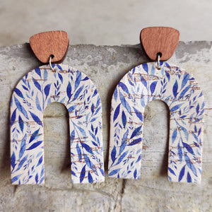 Archway cork statement earrings with blue leaf pattern and wooden top.