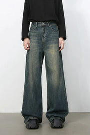 Dark wash wide-leg denim jeans with a faded, distressed look.