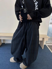 Black pinstripe wide-leg sweatpants with drawstring and pockets.