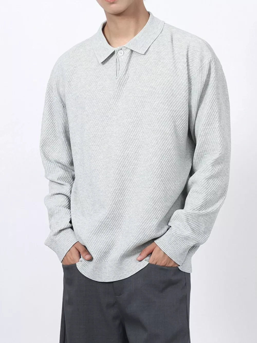 Men's light gray textured knit long sleeve polo shirt with button placket.