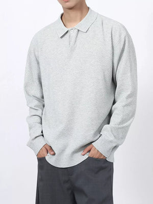 Men's light gray textured knit long sleeve polo shirt with button placket.
