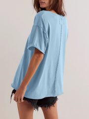 Light blue oversized cotton tee with seam detail and raw hem sleeves.