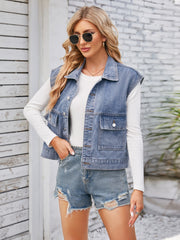 Sleeveless washed denim utility jacket in dusty blue with button front and chest pockets.