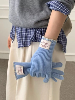 Blue ribbed knit gloves with scalloped cuff detail and a Bonjour label.
