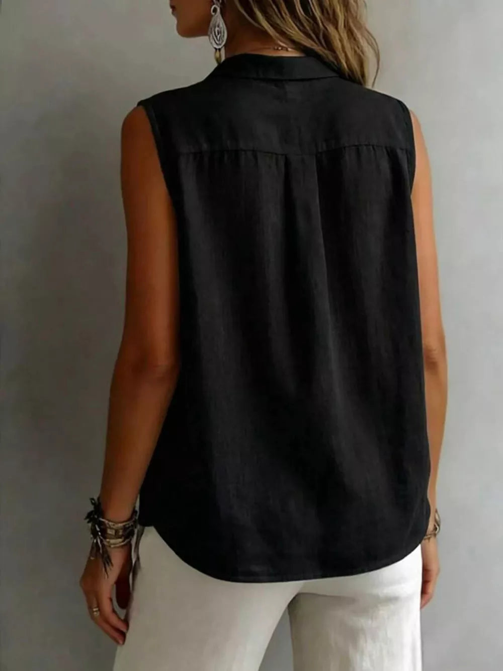 Black sleeveless button-up shirt with collar and back pleats.