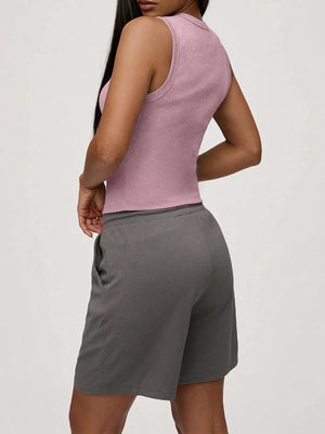 Pink ribbed button-front fitted tank top with a high neckline.