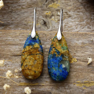 Marbled teardrop gemstone earrings in blue, brown, and gold with silver hooks.