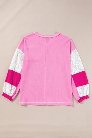 Fuchsia pink waffle knit top with white lace and pink paneled sleeves.