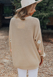Khaki knit sweater with embroidered floral details on sleeves