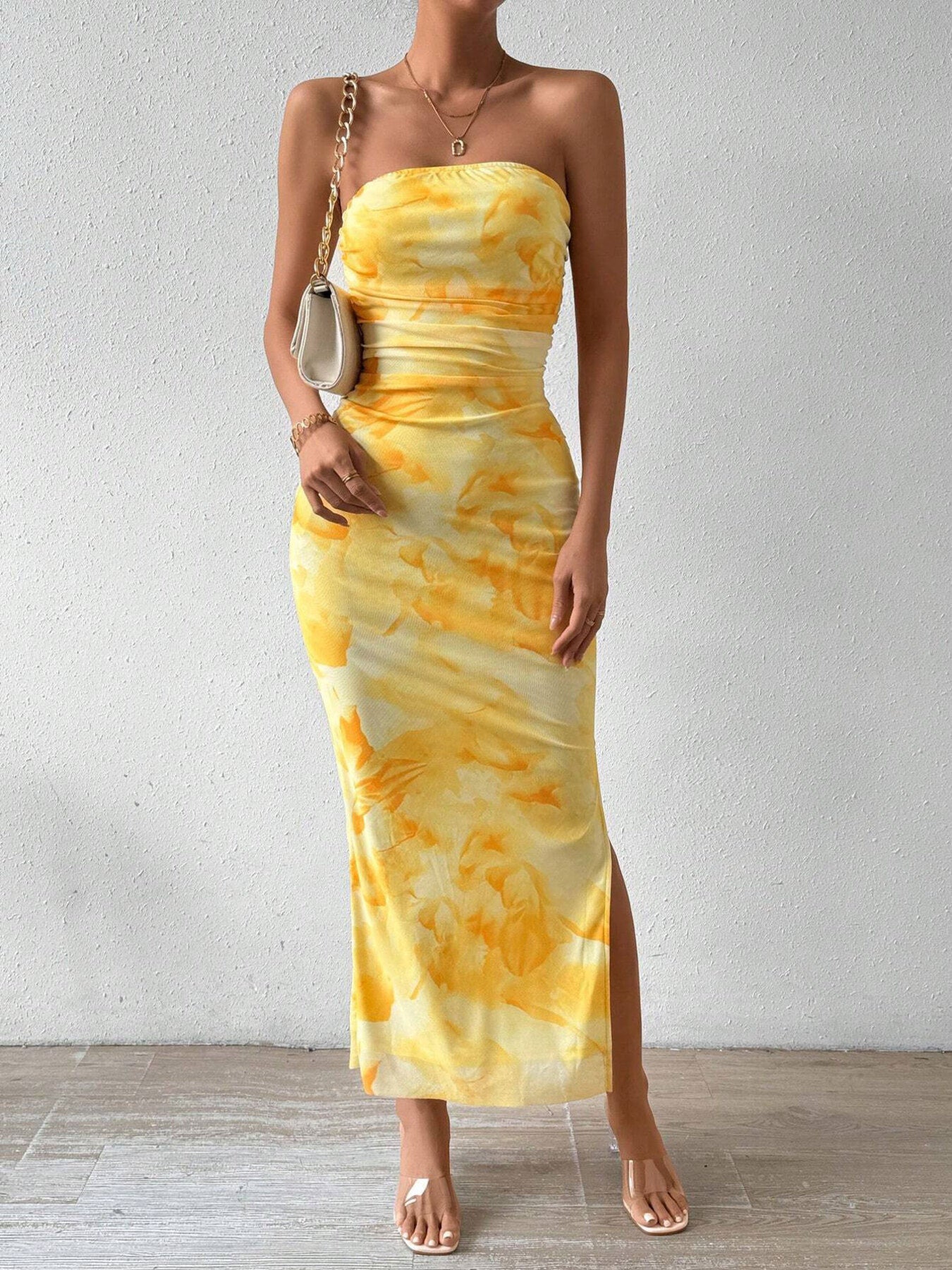 Yellow tie-dye ruched bodycon midi dress with a slit and strapless neckline.
