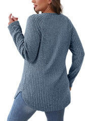Dusty blue ribbed sweater with raglan sleeves and asymmetric hem.
