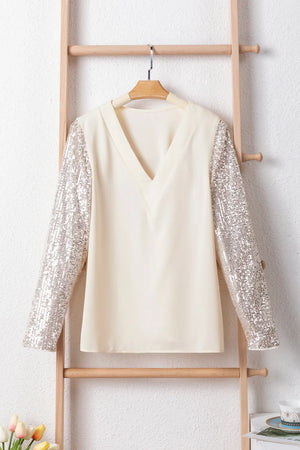 Ivory silk blend blouse with sequin long sleeves and V-neck.