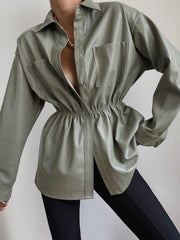 Matcha green faux leather shirt jacket with gathered waist and chest pockets.