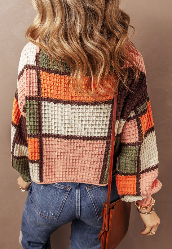 Waffle knit hoodie with patchwork colorblock design in orange, pink, green, and brown.