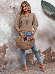 Tiered sleeve jersey tee in mocha with a v-neck, styled with jeans and a straw bag.