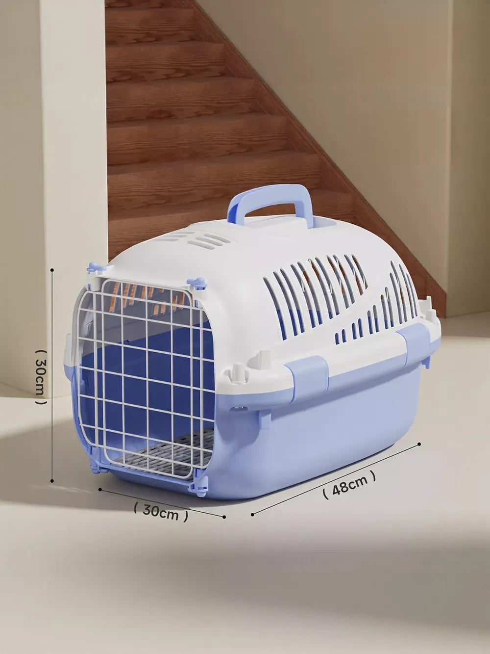 Light blue and white ventilated pet carrier bag with a top handle and secure latch door.