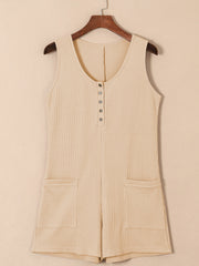 Camel waffle knit button-down romper with pockets and a scoop neck.
