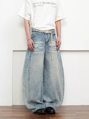 Belted wide leg jeans in light blue denim with a balloon silhouette and rope belt.