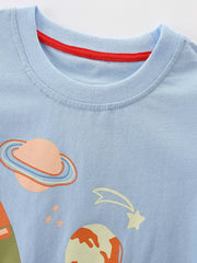 Light blue cotton crew neck t-shirt with space adventure graphic and red neck trim.