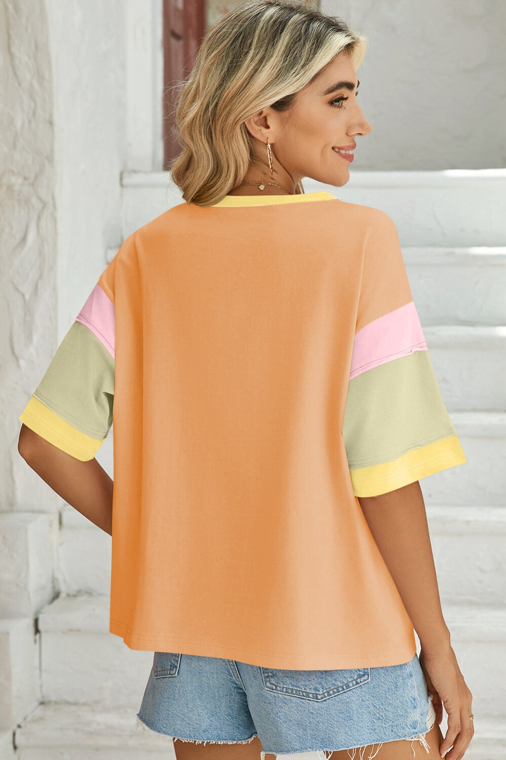 Panel Sleeve Crewneck Tee in orange with colorblock sleeves in pink, green, and yellow.