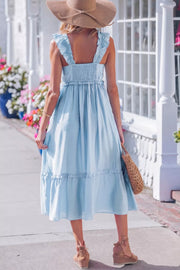 Light blue maternity dress with smocked bodice, ruffle straps, and tiered hem
