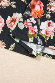 Black floral cotton maxi dress with tiered skirt and smocked waist detail.