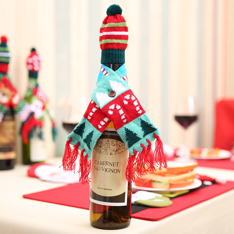 Holiday knit bottle dress with candy cane and tree pattern, red, green, white, and blue accents, and a pom-pom hat.