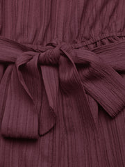 Chic one-shoulder romper in burgundy with a textured fabric and tie waist detail.
