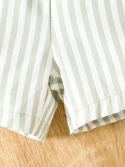 Striped baby shorts in light green and white cotton, showing hem detail.