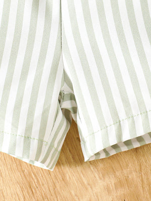 Striped baby shorts in light green and white cotton, showing hem detail.